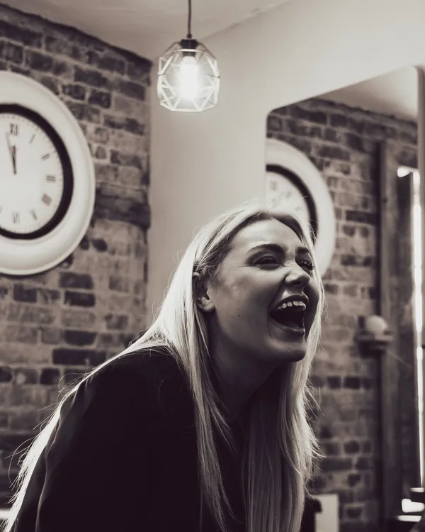 One of our hairdressers laughing in the salon